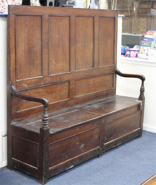 A late 18th / early 19th century oak panelled back box-seat settle W.170cm